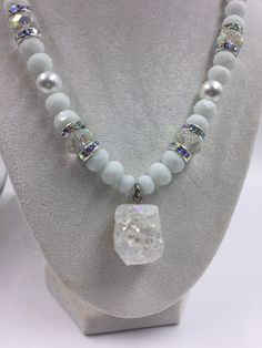 White and clear glass rondelle beaded necklace and silver tone spacers with crystals. White and clear druzy.  Great for any social event. Catch the eye of everyone in the room. This necklace makes the statement for you! Wear it with your favorite pair of jeans or dress it up for a day at the office.  Gift for her, wedding, bridesmaids gift, bachelorette party, wedding jewelry, church, First Sunday, Baptism. Measurements: Length - 18 inches White Bling Round Beads Jewelry, White Crystal Necklace With Rhinestones, White Crystal Beaded Necklaces With Rhinestones, White Crystal Sparkling Necklaces, White Crystal Necklaces With Round Beads, White Faceted Crystal Necklaces, White Faceted Crystal Necklace, Sparkling White Crystal Jewelry, White Crystal Beaded Necklaces For Jewelry Making