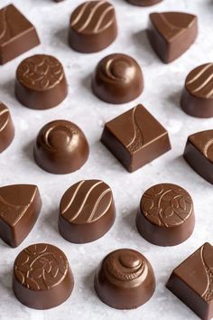 chocolates are arranged in rows on a sheet of wax paper, ready to be eaten