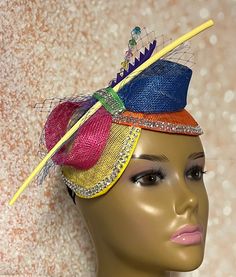 This Yellow, blue, green, pink, and orange multicolor double disc Sinamay fascinator is trimmed with veil netting, feather stem, sinamay bows, rhinestones and hat pin. The hat pin may vary and is for decorative purposes only. The hat measures approximately 9.5 by 4.5 inches. The hat affixes to the head by a hat elastic/string. Handmade SHIPPING All items for free shipping will be shipped via USPS FIRST CLASS MAIL. Adjustable Multicolor Party Costume Hat, Adjustable Multicolor Costume Hats For Parties, Multicolor Headband For Carnival, Multicolor Carnival Headband, Elegant Multicolor Headband For Party, Adjustable Multicolor Headband For Party, Elegant Multicolor Party Headband, Multicolor Carnival Headband Costume Hat, Adjustable Multicolor Headpieces For Carnival