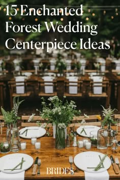 a table set up for a wedding with flowers and greenery