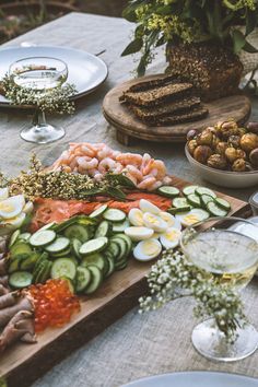 a table topped with lots of different types of vegetables and food on top of it