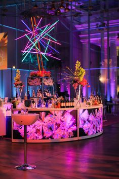 the bar is decorated with bright lights and flowers