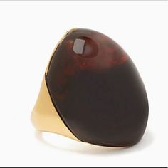 a ring with a large brown stone on it