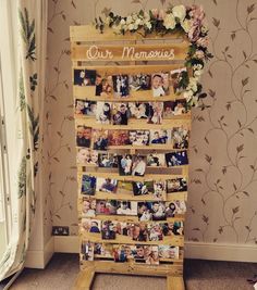 a wooden rack with pictures and flowers on it