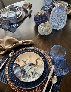 the table is set with dishes and silverware