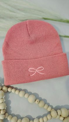 This Pink Beanie is a stylish accessory featuring a charming Coquette Bow embroidered on the front. Made for both warmth and fashion, it adds a touch of elegance to your winter ensemble. Casual Winter Hats With Letter Embroidery, Trendy Adjustable Pink Beanie, Cute Pink Yarn Beanie, Cute Pink Winter Beanie, Pink Cute Soft Knit Beanie, Pink Cotton Beanie, Girl Beanie, Cute Beanies, Pink Beanies