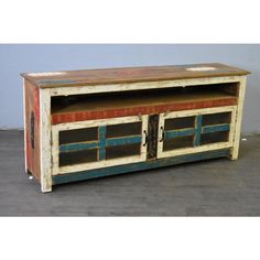 an old wooden tv stand with painted doors