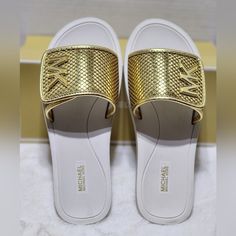 Nwt Michael Kors Authentic Women's White Gold Slip On Slides Sandals Size 10m New And With Box Perfect For A Gift If You Have Any Questions, Let Me Know Pet And Smoke-Free Home Thank You For Looking Gold Open Toe Synthetic Slides, Gold Open Toe Slides, Gold Synthetic Open Toe Slides, Gold Flat Slides, Gold Synthetic Slides For Beach, Gold Synthetic Slides For Vacation, Gold Slides With Textured Footbed, Michael Kors White Sandals For Spring, White Michael Kors Sandals For Spring