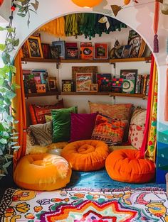 a living room filled with lots of colorful pillows and decor on top of a rug