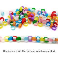 there are many different colored plastic objects on the table and one is saying, this item is kit the garland is not assembled