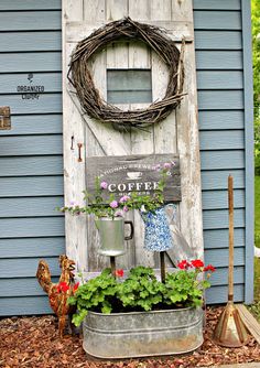 an old door is used as a planter for flowers and other things to decorate