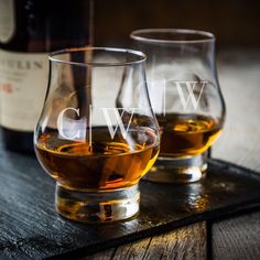 two glasses sitting on top of a wooden table