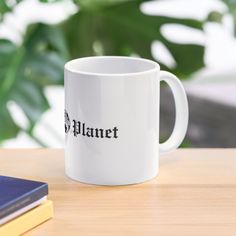 a white coffee mug sitting on top of a wooden table