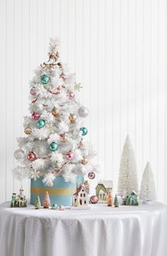 a white christmas tree sitting on top of a table