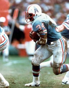 an autographed photograph of a football player running with the ball in his hands