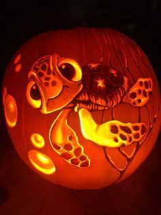 a carved pumpkin with an image of a dog on it's face and paw prints