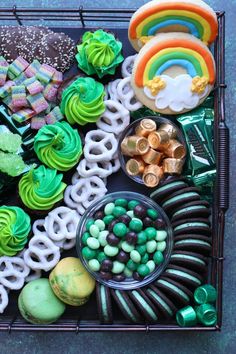 a tray filled with lots of different types of cookies and candies on top of each other