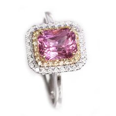 a pink and yellow diamond ring on a white background