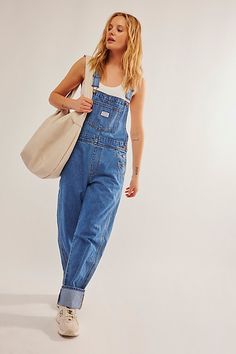 The perfect vintage-inspired overalls from Levi's, this distressed style is featured in a classic bib-and-brace silhouette with front pouch pocket and relaxed, straight leg design. * Adjustable straps * Four pocket design * Side button closures * Logo patch detail at front | Levi's Vintage Overalls at Free People in Medium Wash, Size: XL Cute Overall Outfits, Free People Overalls, Vintage Summer Outfits, Cute Overalls, Vintage Overalls, Overall Outfit, Modest Summer Outfits, Summer Dress Outfits, Summer Outfits Men