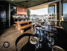 a restaurant with tables and chairs overlooking the water