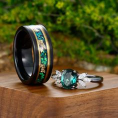 two wedding bands with green and white flowers on them, one is made from wood