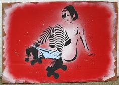 a painting on the side of a building with a woman holding a skateboard in her hand