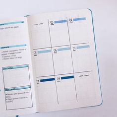 an open planner book with blue lines on the pages and numbers in each page, sitting on a white surface