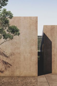 two concrete buildings with trees in the background