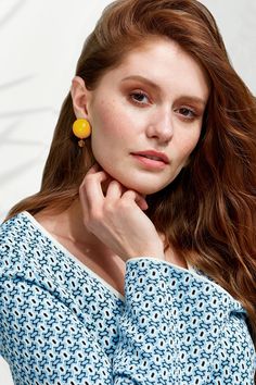 Channel your feminine energy with Luna Petite Earrings—statement studs with dangling crystals and beads that sparkle like stars in the light. Luna Petite is a scaled-down version of the oversized Luna Earrings, in a more primary color palette. Like the moon, you are a source of illumination. Luna Petite Earrings’ spherical shape gives you just enough gravitational pull. Hand-painted with Non-Toxic Paints (ACMI’s Approved Product Seal)Czech Glass BeadsWood BaseUpcycled Vegan Leather BackingStainl Crystal Dangle Earrings With Dangling Beads, Primary Color Palette, Petite Earrings, Yellow Shop, New Version, Earrings Statement, Feminine Energy, Yellow And Brown, Czech Glass Beads