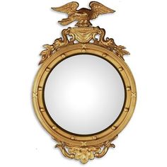 an ornate gold framed mirror with two birds on the top and one eagle above it