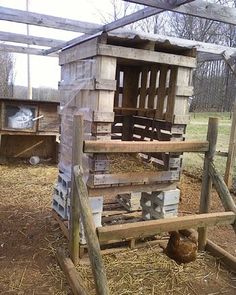 a chicken house made out of pallets and wood