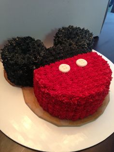 two cakes decorated to look like mickey and minnie mouse ears on top of each other