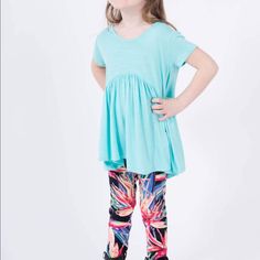 Made From Easy To Care For Rayon Spandex Knit, This Flattering And Fun Top Is Perfect With Your Favorite Kids Leggings Or Jeans. 95% Polyester 5% Spandex Arched Empire Waist. Gathered Peplum. Rounded Neckline Flattering 'Perfect Sleeve, Hip Grazing Hem Made In The Usa From Imported Materials New With Tags From Smoke And Pet Free Boutique. Sizes: Xxs - Child's 1-2 Xs - Child's 2-4 S - Child's 4-6 M - Child's 7-8 L - Child's 10-12 Xl - Child's 12-14 Playful Light Blue Tops For Spring, Playful Light Blue Tops For Playwear, Cute Blue Tops For Playwear, Light Blue Casual Tops For Playwear, Playful Fitted Blue Tops, Playful Stretch Tops For Playtime, Playful Stretch Blue Top, Stretch Playful Tops For Playtime, Playful Light Blue Tops For Playtime