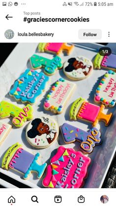 some decorated cookies are sitting in a box on top of a table with other items