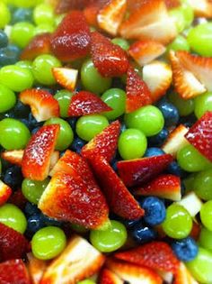 mixed fruit salad with grapes, strawberries, oranges and kiwi