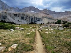 a dirt path in the middle of a mountain range