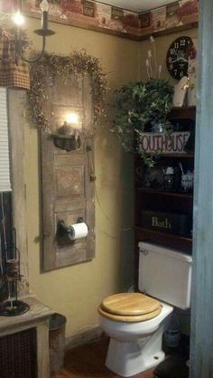 a bathroom with a wooden toilet seat next to a wall mounted mirror and potted plant