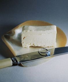 a piece of cake sitting on top of a plate with a knife next to it