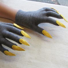 a pair of gloves with yellow claws on them