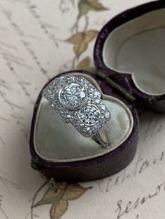 A trio of scintillating old European cut diamonds, together weighing 2.65 carats, flash across the face of this streamlined Edwardian / Art Deco finger hugger. Expertly crafted in platinum, three sparkling diamonds radiate from within a twinkling border of rose cut and old mine cut diamonds. Stunning from all angles. Currently a ring size 6 3/4. Center diamond: 1 ct., G color, VVS2 clarity Side diamonds: approximately .45 ct each, H-I color, one diamond is SI1 clarity, the other VS1 Diamond bord Art Deco Three Stone Diamond Ring, Cluster Three Stone Diamond Ring For Anniversary, Three Stone Cluster Diamond Ring For Anniversary, Diamond Trilogy Ring, Vs1 Diamond, Trilogy Ring, Edwardian Art, Quartz Crystal Necklace, Sapphire Diamond Ring