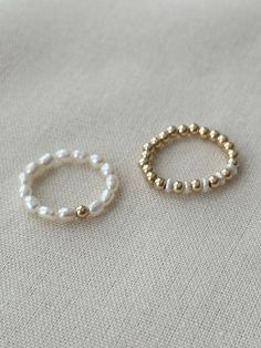 This beaded freshwater Pearl ring set adds elegance to your everyday jewelry look! Each dainty ring is hand beaded just for you! These gorgeous genuine Pearl rings are accented with sensitive skin safe 14K Gold Filled. * 3mm natural freshwater Pearls * 14K Gold Filled accent beads * Rings may be purchased as a set, or single from the drop down menu below. Extra Small ring fits US 4-5 Small ring fits US sizes 6-7 Medium ring fits US sizes 8-9 Large ring fits US sizes 10-11 See all Pearl Jewelry h Pearls Ring, Ring Pearl, Cute Jewelry Rings, Bead Ring Ideas, Seed Bead Ring, Beaded Ring, Seed Bead Rings, Diy Ring