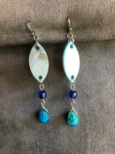 Light and swinging these blue dangles have a sheen of mother of pearl. With glass bead accents complimenting the pointed oval, these will have people turning to look. The colors of the ocean flow into your hair and show off your style. Wear them at the beach, the pier, pool or to your dinner date. Fun gift for a friend, teacher or yourself. Blue Bohemian Pearl Drop Earrings, Blue Pearl Drop Bohemian Earrings, Blue Dangling Beads Teardrop Earrings, Adjustable Blue Teardrop Dangle Earrings, Blue Dangle Earrings, Dinner Date, Etsy Earrings Dangle, Ocean Blue, Glass Bead