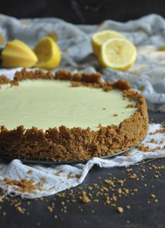 a cheesecake with lemons and crumbs around it