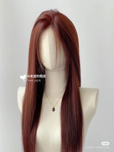 a wig with long red hair on a mannequin head