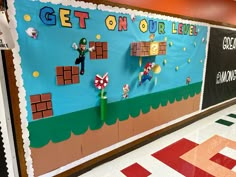 a bulletin board with mario and luigi on it in a school hallway that says get on our life