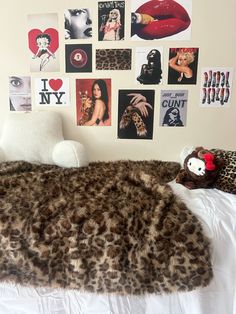 a bedroom with pictures on the wall and a teddy bear