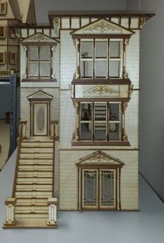 a paper model of a house with stairs and windows