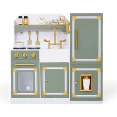 a green and white toy kitchen with gold trimmings on the doors, stove top oven and sink