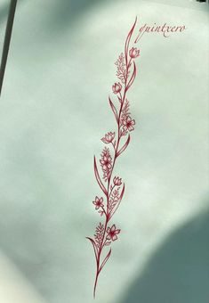 a piece of paper with red ink on it and a flower drawn on the side