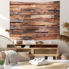 a wooden wall hanging over a table next to a wicker chair and potted plant